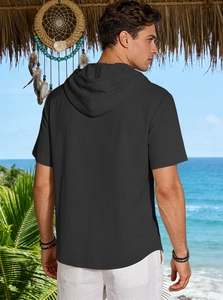 Rear view of black breathable linen hooded shirt for men on a tropical beach background