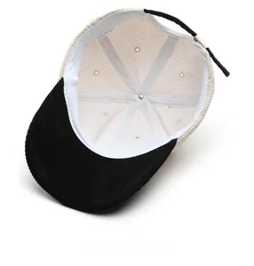 Detailed interior of corduroy baseball cap with adjustable strap and stitching
