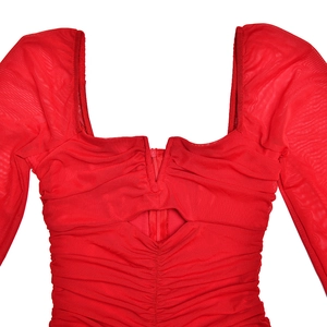 Detail of red mesh dress showing square neckline with front zipper and hollow-out design
