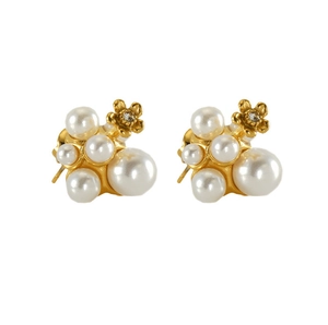 Close-up of pearl cluster earrings with gold flower charms and zircon inlay