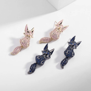 Detailed close-up of fox-shaped earrings with pink and dark blue pavé zircon crystals