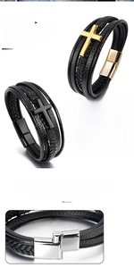 Close-up of multilayer braided leather bracelet with cross pendant and magnetic alloy clasp