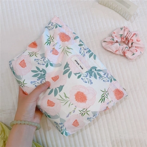 Detail of floral cotton makeup bag with pink peony print and simple wish label