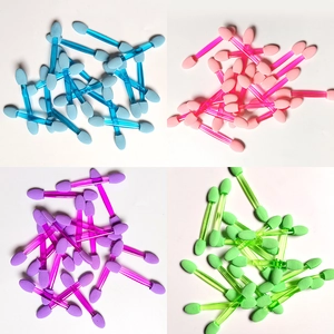 Macro view of four-color double-sided sponge eyeshadow applicators for makeup and nail art