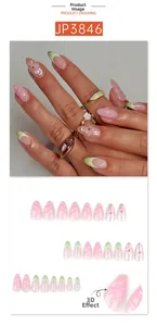 Close-up of green gradient press-on nails with 3D floral accents and gold beads