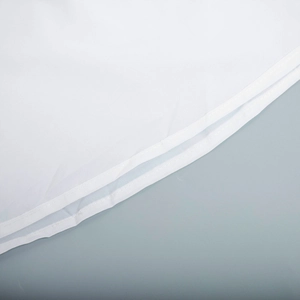 Detail shot of white floral maxi dress showing high-quality double-row stitching and hem finishing
