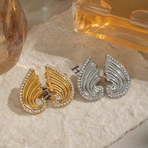 Sparkling diamond-encrusted wing stud earrings in 18K gold and silver finishes