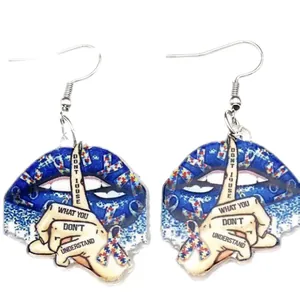 Detail of acrylic blue lips earrings with autism awareness puzzle hand and size info