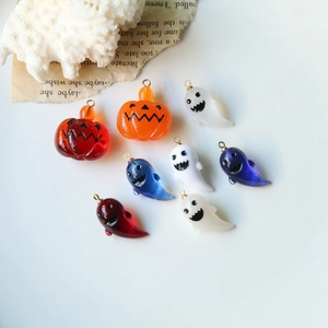 Detail showing colorful 3D resin pumpkin and ghost pendants for DIY Halloween jewelry