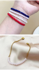 Detail of multi-color faceted bead bracelets with gold chain and lobster clasp