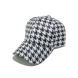 Close-up of houndstooth baseball cap showing high-quality fabric texture and visor detail