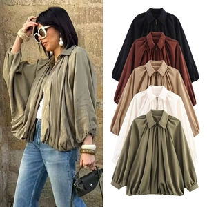 Detail of a women's puff sleeve baseball jacket with zip-up design in five solid colors