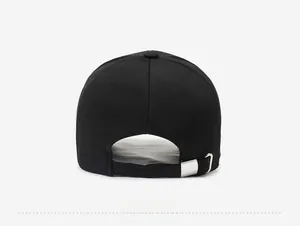 Rear view of black cotton baseball cap showing adjustable strap and silver metal buckle