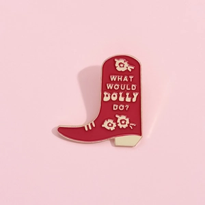 Creative red cowboy boot enamel brooch with What Would Dolly Do lettering on pink back
