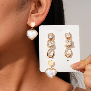 Retro 12-piece earring set featuring pearls, rhinestones, and heart shapes for women