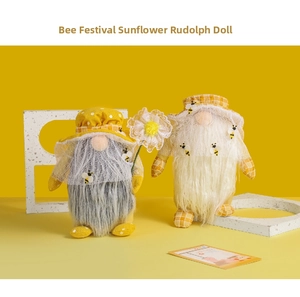Close-up of plush bumblebee gnomes with sunflower and dotted hats for holiday decor