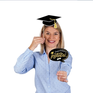 Close-up of 2026 graduation party photo booth props with cardstock and wooden sticks
