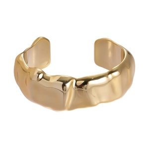 Minimalist gold cuff bracelet featuring irregular wavy molten texture and open design