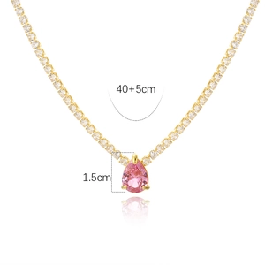 Detail shot of tennis necklace showing 1.5cm pink heart pendant and 40+5cm gold chain