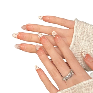 Handmade floral press-on nails with almond shape, pink gradient, and 3D butterfly charms