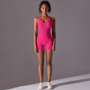 Detail of rose pink seamless yoga romper showing compression texture and high-stretch fabric