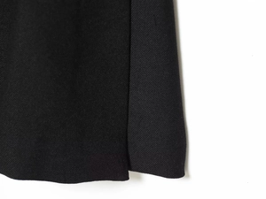Macro shot of high-quality black twill fabric texture and stitching for women's blazer