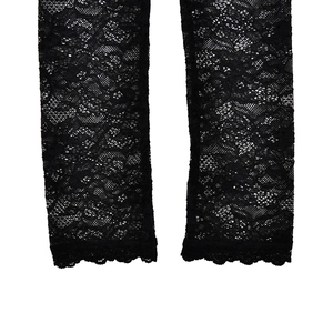 Detail shot of black lace sleeves featuring intricate floral patterns and scalloped edges