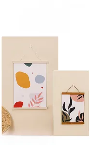 Detail of wooden magnetic hanger frames in light and dark oak with abstract art