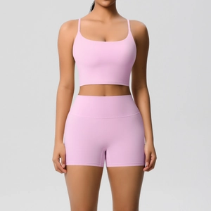 Front view of a light pink yoga set featuring a thin strap sports bra and high-waisted shorts