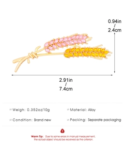 Detail view of wheat brooch with pink and yellow crystals and size specifications