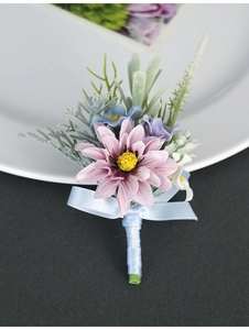 Detail of pink and blue artificial boutonniere with silk petals and ribbon for weddings