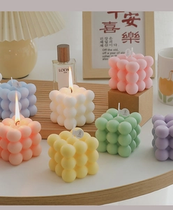 Detailed view of colorful cube bubble candles in pastel tones for home decor