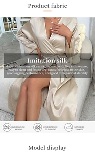 Detail of champagne imitation silk robe fabric with luxury satin finish and belted waistline
