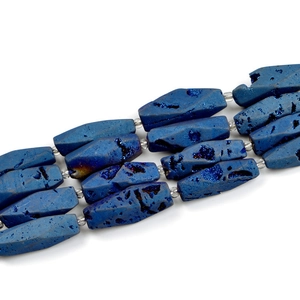 Macro shot of dark blue octagonal agate beads with iridescent crystals and texture