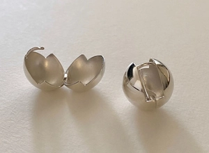 Macro view of S925 sterling silver ball earring featuring a unique hinged opening design
