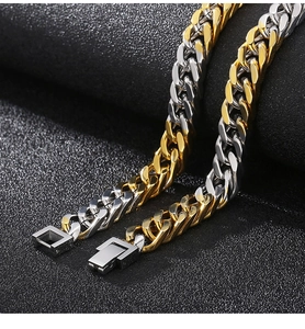 Detail of silver and two-tone gold Cuban link necklaces with square box clasps