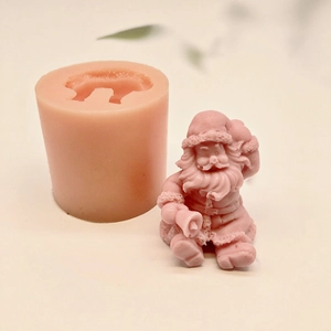 Pink sitting Santa Claus silicone mold for DIY candles and soaps on a light background