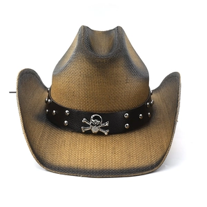 Detail of western straw hat with brown gradient, skull buckle and studded leather band