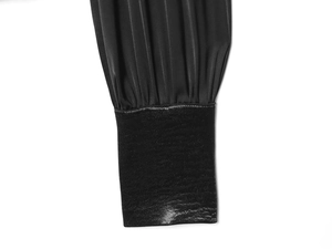 Close-up of black shirt sleeve cuff showing fabric texture and elastic wrist detail