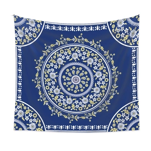 Close-up of blue bohemian mandala tapestry with intricate white and yellow floral details