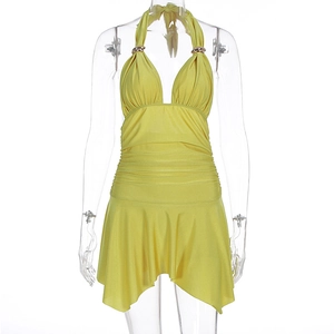 Detail of bright yellow halter dress featuring gold metal rings and pleated waist