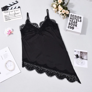 Detail of black satin camisole with lace trim and asymmetrical hem on a stylish flat lay