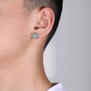 Close-up of hip-hop square iced-out stud earrings with silver finish and pavé zircons