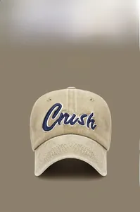 Close-up of Crush 3D navy embroidery on washed cotton beige baseball cap fabric