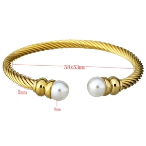 Detailed view of gold twisted cable bracelet with pearls and 58x53mm inner diameter size