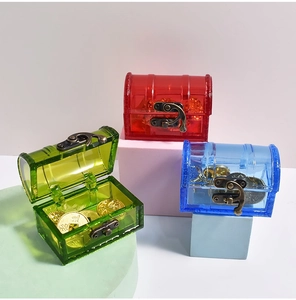 Close-up of colorful mini treasure boxes with vintage metal buckles and gold coins