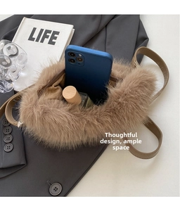 Detail of plush crossbody bag interior showing space for a smartphone and accessories