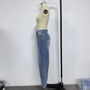 Detail view of washed light blue denim jeans showing the side profile and loose wide-leg cut