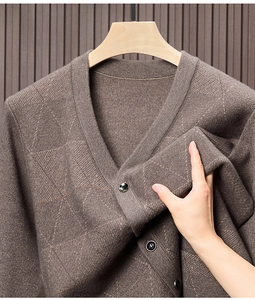 Detailansicht der braunen Strickweste mit Rautenmuster-Textur und dunklem Knopf