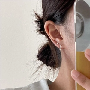 Sterling silver geometric bead stud and hoop earring set shown on model in a minimalist style